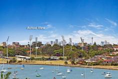 54A Burns Crescent Chiswick NSW 2046 sophisticated offering of unquestionable quality and refinement in a
blue ribbon harbourside setting, this breathtaking residence is quite
simply beyond compare. Flowing over three levels and finished to the
highest of standards, panoramic views stretch across the bay to the
distant skylines of North Sydney and the CBD. Occupying an elevated
setting that embraces privacy and tranquillity and flooded with natural
northern light throughout, this family home is designed for easy, low
maintenance entertaining. An ultra-contemporary masterpiece of rare
quality, it is minutes to parks and village life. Bright split level lounge and dining area, featuring in/outdoor ponds Marble tiled entertaining terrace, BBQ outlet and roof top garden Separate family room and theatre room / 4th bedroom with ensuite Generous master with walk-in robe, unique open ensuite with views Deluxe kitchen, CaesarStone island bench and glass splash-backs Sun-washed rear courtyard, sparkling lap pool with water feature Gas fireplace, heated tiled floor, polished timber and ducted air con y