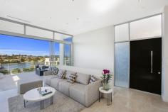 54A Burns Crescent Chiswick NSW 2046 sophisticated offering of unquestionable quality and refinement in a
blue ribbon harbourside setting, this breathtaking residence is quite
simply beyond compare. Flowing over three levels and finished to the
highest of standards, panoramic views stretch across the bay to the
distant skylines of North Sydney and the CBD. Occupying an elevated
setting that embraces privacy and tranquillity and flooded with natural
northern light throughout, this family home is designed for easy, low
maintenance entertaining. An ultra-contemporary masterpiece of rare
quality, it is minutes to parks and village life. Bright split level lounge and dining area, featuring in/outdoor ponds Marble tiled entertaining terrace, BBQ outlet and roof top garden Separate family room and theatre room / 4th bedroom with ensuite Generous master with walk-in robe, unique open ensuite with views Deluxe kitchen, CaesarStone island bench and glass splash-backs Sun-washed rear courtyard, sparkling lap pool with water feature Gas fireplace, heated tiled floor, polished timber and ducted air con