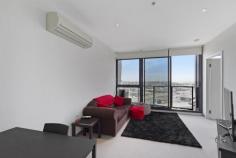 1405/109 Clarendon Street SOUTHBANK Vic 3006 $379,000 Prominently situated win the landmark '109 Clarendon' building, this sensational, high-rise apartment effortlessly delivers style and easy living in the ultimate of Southbank locations. The apartment, designed spaciously over 46 squares), offers a naturally-illuminated living and dining domain enhanced spectacularly with floor-to-ceiling windows, and sliding door to the balcony providing a sublime space to dine alfresco as you take in the far-reaching views over Port Melbourne to Hobson's Bay. The spacious bedroom, also enjoying superior views via full-height expansive and curved windows, and a wall of mirrored robes, is more than adequately serviced by the chic bathroom with a European laundry, and a stylish kitchenette, superbly appointed with sleek stone surfaces, large fridge space, plentiful cabinetry and stainless-steel appliances (gas cooktop, range hood electric oven and dishwasher).