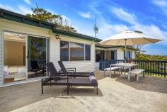 47 Vista Avenue North Copacabana, NSW 2251 Nestled in the dress circle locale of Vista North Avenue looking towards
the Pacific, this quintessential beach house will suit either a coastal
family wanting to get their foot in the door to buy a view or an
investor who sees the prime opportunity of such useable land with
outlook.
– Panoramic ocean and valley views capture Copacabana, MacMasters Beach and Sydneys coastline to North Head
– Unique corner block with easy access- useable 550sqm of land
– Flat front and rear yards for hours of enjoyment for the children to run around in
– Large open plan living room with sunken lounge area basking in the views
– Open plan kitchen and dining
– Three bedrooms all with built in robes
– Timber floors, air conditioning, Foxtel
– Family bathroom with separate WC
– Single remote lock up garage & storage, extra parking for multiple cars
– Easy to maintain gardens, undercover entertaining to the rear
– The large entertaining deck is where you will spend time creating
endless memories, enjoying ocean vistas by day and spectacular pink
sunsets by night, including Sydney New Years fireworks