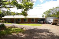 30 Witta Road Maleny Qld 4552 Set at the rear of this 7589m2 block (almost 2 acres) this low set brick
home has been specifically sited to take advantage of the expansive
north facing views. This is a very special piece of land and subject to
new Council regulations and approvals a second dwelling may be
permitted. The existing home has four large bedrooms all with built-ins.
Huge views from the kitchen which is combined with the family meals
area and the separate lounge room has a pot belly stove. There is a
large laundry and utility area with good storage. The spacious rear
entertainment area takes advantage of the magnificent outlook. There is a
20,000 gallon water supply, lock up garage, steel shed & undercover
caravan parking. There is also plenty of room to keep horses other
anaimlas or build a huge shed. Less than 10 minutes drive into Maleny
privacy is guaranteed at this address.