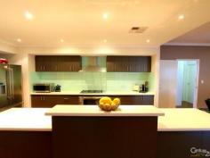 79 The Promenade Wattle Grove WA 6107 Wattle Grove Masterpiece Inspection Times: Sun 09/11/2014 02:00 PM to 02:30 PM As soon as you step into this beautifully presented property you will be impressed by the size and space this 4x2 family home has to offer. High ceilings throughout add to the sense of space in this home as you step through the double front doors into the large foyer. You will be blown away by the sheer size of the master bedroom and en-suite bathroom with double vanities, twin shower heads, separate toilet and his and hers walk-in robes. Walking into the main living area again you will be wowed by the beautiful solid timber floors which are throughout the home and by the size of the open plan living/dining and beautifully appointed kitchen with stainless steel appliances, glass splash backs, corian bench tops and an abundance of cupboard space which is complimented by a huge walk-in pantry. A large theatre room with twin entries awaits off the foyer and living areas and is perfect for a family movie night. The remaining three queen size bedrooms all have built-in-robes with the laundry also having a large walk-in linen cupboard and plenty of cupboard space. The open plan living area opens out onto a large timber deck area with built-in cupboard and sink perfect for outside dining. The deck is wired for sound and there is a large powered shed again with a sink. There is also side access with enough room for a caravan or boat. Close to transport, shops and within walking distance to the local primary school you can simply move in and start living as everything in this home has been carefully thought out for easy family living.