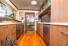 2 Kinship Way Atwell WA 6164 DESIGNER FAMILY HOME...PICTURESQUE PARKLAND VISTA! Web property id: TRE147 Set in the award winning Harvest Lakes Estate is this former display home, built by the highly regarded Rural Building Company with approx 250sqm of internal living space on a large 769sqm corner block and showcasing stunning parkland views that enhance ambience and appeal, in this truly gorgeous home. With a fantastic well thought-out family-friendly floor plan promoting great separation of living, with the parents’ wing on the opposite side of the home to the childrens’ wing, this home is complete with four bedrooms, office, kids activity, two bathrooms, multiple living areas including home cinema, galley style kitchen, large laundry, timber decking, alfresco Balinese style hut, and double lock up garage. The centre of the home is the massive open plan living and dining area with a striking Toodyay stone gas log fireplace, Marri timber floors, 11 metre wide raked ceilings with exposed beam and a delightful views over opposite parkland including its Cypress Pines...what an enchanting vista! A galley style kitchen is also central to the home and is equipped with Essa stone benchtops, stainless steel appliances including a dishwasher, gas hotplate, tiled splashback and abundance of storage cupboards. You’ll never need to visit a Hoyts cinema again with this impressive fully equipped home cinema to watch your favourite shows, the latest blockbusters and sporting fixtures...just bring the popcorn, dim the lights, let the show begin! The childrens’ wing also has its own play room/activity centre, well away from rest of house and central to their bedrooms – a great space for bookshelves, toys, their own TV or homework zone. Other features include: two evaporative ducted air-conditioners, recessed lighting, quality carpets, inbuilt speakers, intelligent wiring, solar panels, solar hot water system, security alarm, auto reticulation in garden and alfresco timber decked areas for entertaining and relaxation. Outside the home has fully landscaped gardens with ample room for a pool...the inviting and intimate resort-style Balinese hut is the ultimate place for a Sunday afternoon beer, wine or cocktail with family and friends. Located in a family friendly, master planned community close to amenities and surrounded by quality homes; within walking distance to both Harmony Primary School and Atwell High, it’s an extremely convenient and appealing home, built to facilitate a relaxed WA lifestyle in comfort and style. Highly motivated owner has priced this home for immediate sale so here is your opportunity to own this unique family home with its lush green parkland vista in this highly sought after location...so act immediately! For more information on this magnificent home or to arrange your private viewing please contact Derick and Bev PITT from THRIVE Real Estate on 0438 011 690 or 9414 9440.