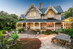 11 Holbrook Ave Kirribilli NSW 2061 Lifestyle - Built circa 1857, this historic waterfront estate,
'Sunnyside', is one of Sydney's finest properties, occupying a prime
location on Sydney Harbour. This iconic landmark boasts a long history
of pedigreed owners and comes onto the market after 43 years. Nestled
amid 1250 sqm of beautiful gardens on the tip of the Kirribilli
peninsula, it's immensely private with superb boating facilities. The
meticulously and respectfully restored and updated sandstone home
captures gun barrel views down the harbour past Fort Denison to Shark
Island and Vaucluse.
Accommodation - Retaining enormous traditional appeal, the expansive
two-storey residence contains four large bedrooms, including a huge
master suite with a private study, along with two luxurious Carrara
marble bathrooms. An abundant choice of entertaining space includes
grand formal lounge and dining rooms, an elegant sitting room and a
casual living area with soaring ceilings, encompassing a bespoke
travertine Miele gas kitchen. A spacious office is privately secluded
among the gardens.
Features - Located just 50m from the ferry which takes you to Circular
Quay in only seven minutes, the property enjoys use of a shared jetty
plus a private electric boat hoist and tie-up area. Framed by wide,
shady verandas and pretty sandstone-flagged terraces