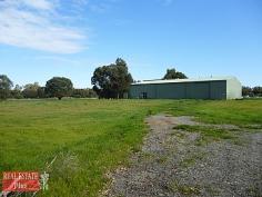 1973 Great Northern Hwy Bullsbrook WA 6084 Perfectly positioned on the south side of Bullsbrook, is this superb piece of Australian land. With
flat land adjoining the highway there is enough space to have a buffer
zone from the main part of the block. The block is separated by a brook
and the back part of the property is gently sloping in some parts and
lightly treed. The standout feature of the property is the
MASSIVE workshop with an office space and full bathroom all inside.
Outside there are also small carriage like rooms which could also be
used as extra workspace as there is one that's just a room, one that is a
room...