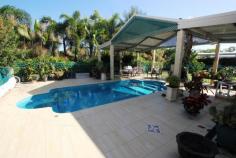 22-24 Tulloch Avenue Barmaryee QLD 4703 Massive home on 1 acre is an absolute bargain This 432m2, 5 bedroom home on 4217m2 corner block has everything plus privacy is assured behind security fencing with electronic gates. Also included is a 162m2 shed for dad, a pool for the kids & much more. Modern kitchen with stone benchtops, formal dining, family & lounge Wrap around verandah provides multiple outdoor entertaining areas 4 bay carport + undercover parking for caravan, boat, golf buggy & more Generous master suite with huge ensuite & wir/dressing room The home is fully airconditioned, has solar hot water and 5kw of solar panels Fully automated watering system with water supplied by tanks & bore Only a personal inspection will reveal everything this home has to offer but you need to inspect now as this home is priced well below replacement cost. General Features Property Type: House Bedrooms: 4 Bathrooms: 2 Land Size: 4000 m² (approx) Outdoor Features Garage Spaces: 12 Other Features Property Type: House House style: Lowset Construction: Brick Roof: Colour steel $699,000