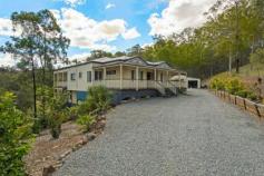197 Tarata Rd Guanaba QLD 4210 ORGANIC ACREAGE WITH DUAL LIVING
Stylish Bluestone electric gates welcome you to your
own little piece of paradise tucked away in the Gold Coast Hinterland
found in the Guanaba Valley beneath Mt Tamborine. From the moment you
step onto this amazing 7 acre property you will immediately get a calm
sense of serenity. This fantastic elevated metal framed multi-level
Queenslander is perched upon rolling acreage that has been re-vegetated
with native plants, terraced gardens, citrus trees and a dam with
Muscovy ducks and wild geese to match. If you are seeking a
lifestyle change from the hustle and bustle of town to enjoy the simpler
things in life, such as growing your own veggies and raising your own
livestock, then this is the ultimate “tree-change” for you. With enough
space for the kids/grandkids to ride bikes or ponies or to run a home
operated business from the large 3 bay shed, 2 families could also
easily combine here as the home has been designed with dual living in
mind, all that needs adding is a kitchenette and you're set. Upstairs featuring: - Polished timber floors - Master bedroom with large en-suite and WIR - Beds 2 and 3 extra large size with BIR and study nook - Separate main bathroom - Extra-large separate carpeted formal lounge/dining room with beautiful French doors - Large open plan family/meals area adjoining kitchen and upper deck with fireplace for those cosy winter nights - White and modern 'country style' kitchen with ample storage and bench space, gas cooking and dishwasher - Timber deck overlooking property with plumbed in gas line for BBQ's - Air-conditioning throughout - Solar power (1.7kw)