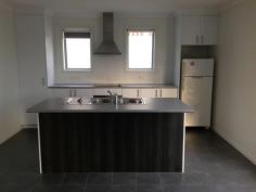 Unit 2/55 Horizon Drive Sorell Tas 7172 $265,000 Modern Home With Delightful Views 2/55 Horizon Drive, Sorell Price: S275,000 Unit size: Approx 102m2 Land area: Approx 265m2 THERE are delightful views away to Orielton Lagoon on Pittwater and beyond to Mt Wellington from this well-presented brick home with level, easy care and sunny grounds. Elevated above the township of Sorell in a rapidly expanding new homes area, the contemporary abode is well-laid out with a neutral décor. In a complex of three, the main entry is from a front verandah with timber decking to a bright, open plan lounge/dining area with a carpeted floor and a Fujitsu reverse cycle air conditioner. Adjoining is a neat, modern kitchen with an island workbench/breakfast bar, a ceramic cooktop, a stainless steel range-hood and a stainless steel under-bench oven, a tiled splashback and there's a pantry cupboard. A central hallway with an electric panel heater provides access to two good sized bedrooms with built-in wardrobes and the master also having an en suite bathroom while the tiled family bathroom has a bathtub, a separate shower bay, a vanity unit and a Tastic light/heater/exhaust. At one end of the hall is a handy powder room and at the other, the laundry with storage and door to the yard and nearby attached carport and concrete driveway for extra parking. There also is a quite private concreted barbecue area with rustic views. Property Snapshot Property Type: Unit Construction: Brick Veneer Land Area: 265 m2 Features: Built-In-Robes Close to schools Verandah