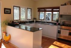 205 Oxley Drive Mittagong NSW 2575 $1,250,000 EMBRACING A SUPERB MASTERBUILT HOME WITH A MAGICAL OUTLOOK SET ON 1.6 ACRES ON THE NORTHERN SIDE OF 'THE GIB' FEATURES OPEN PLAN LIVING WITH GREAT STYLE AND PRESENTATION * 5 bedrooms - all with built-in robes * main upstairs with WIR & split-system air conditioning * 2 bathrooms with under-floor heating - ensuite to main * main bathroom - generous in size, with claw foot bath, frameless shower, Caesar stone vanity & w.c. * powder room with vanity & under-floor heating * open plan lounge & dining with vaulted ceilings, blackbutt parquetry flooring, Jetmaster open fire, ceiling fans, window seat & French doors to north facing deck * well appointed kitchen with granite benchtops, Ilve electric oven & 5 burner gas cookop, dishwasher & butler's pantry * rumpus/media room - sound proofed * study/office * large laundry with plenty of storage & under-floor heating * ducted gas central heating * security alarm system