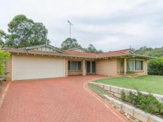 29 Taronga Dr Kelmscott WA 6111 For Sale From $559,000 The owners of this lovely home purchased this property when their children were teenagers. They were looking for a specific property to cater for their needs. Their criteria was that all four children needed their own bedrooms, it had to have a minimum of three large living areas and a low maintenance backyard as they did not require gardens to maintain. This quality 5 bedroom 2 bathroom home ticked all of their boxes and we are certain that it will tick all of yours! Located in a sought after area of the Kelmscott hills, situated on a 715sqm elevated block, you will feel like ?king of the castle? as you take in the views over the treetops. This immaculate home features double door entry and the earthy tones that greet you flow throughout, which only adds to the ambience of this property. The large formal lounge /Dining room, the huge Master bedroom and the first of the children?s bedrooms are located at the front of the house. The main hub of the property is the open plan kitchen/dining/family room. The country style kitchen is definitely the feature as it dominates the space as it is so large. There are an abundance of cupboards, a walk in pantry, island bench, and heaps of workbench space to cook up a storm, simply a ?chefs delight? All the children?s/guest bedrooms have built in robes and are spacious. Both of the bathrooms are large and both contain a bath one of which is a relaxing spa bath located in the ensuite. Other features include a huge games room ideal for that pool table you?ve always wanted, cool ducted air-conditioning, gas heating and easy care light bright slate floors. The home is built back on the block and the patio is the entertaining area which is accessed from the games room. An extra bonus is the bus can pick you up on the street and drop you off to the train station. This is a fabulous, quality built home at a very affordable price. Please call to view!