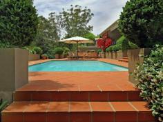 72 Yarrabung Rd St Ives NSW 2075 "VILLA GRANA" ULTIMATE PRIVATE ENTERTAINER Majestically set back from the street with a long paved driveway framed by stunning Cypress Pine and Japanese Box hedges, this ULTRA PRIVATE, Mediterranean influence family residence combines character and contemporary design. Enjoying the versatility of DUAL OCCUPANCY, this stunning home is nestled on an impressive block 1,741sqm approx and offers the ultimate in resort-style living for families that love to entertain. A large North facing sun room and covered terrace stretch the length of the house which flows to opulent and private alfresco entertainment areas, including a sun drenched North facing large swimming pool and spa with a built in barbecue surrounded by stunning manicured gardens. From its imposing Travertine entrance to the open plan kitchen with marble bench tops (island bench) and Miele appliances, the home opens onto a beautiful back garden with expansive level lawns that will be perfect for a game of backyard cricket. The attached apartment is ideal for in laws or family accommodation and includes 2 bedrooms, a bathroom, a spacious dining/lounge area, a lovely kitchen with granite bench tops and a meal area that flows to a private outdoor deck, ideal for alfresco dining. Other features include an immaculate paved driveway with a three car garage and extra parking spaces. The manicured landscape gardens enhance the peace and tranquility of the home. Conveniently located just minutes' walk to St Ives Primary and High schools, bus to city and Gordon station and with easy access to St Ives Shopping Village and many of the area's best schools, including Masada, Brigidine College and Sydney Grammar Prep, this whisper quiet home commands attention. * Striking travertine front entrance and spacious light-filled interiors * Vast open plan formal living and dining with a built in fire place * Sundrenched sitting area with bay windows overlooking private garden surrounds * Gourmet kitchen with Carrera marble island benchtop and Miele appliances * Five generous bedrooms with built ins, master with ensuite and adjoining home office * Travertine family bathroom; polished timber floors in living; plantation shutters * Downstairs rumpus adjacent to swimming pool ideal for a game of table tennis * Dual occupancy boasting separate granite kitchen, spacious living and dining * Three-car garage with storage and internal access, security gates * Expansive under-house wine cellar, ample storage, central heating * Spacious laundry * Private and secure This amazing residential setting is a MUST TO INSPECT!!