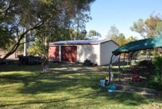 9 Lalor St Roma QLD 4455 FOR SALE $525,000 This spacious air-conditioned brick family home on over 2 acres at Orange Hill is priced to sell! The house comprises four built-in bedrooms (three with northern aspect " main opening to front patio), carpeted loungeroom, spacious kitchen with gas stove and pantry, dining area off kitchen, large rumpus room with wood heater, bathroom with separate bath, shower and vanity, separate toilet and spacious rear laundry/sewing room. Extra improvements include double lock-up shed, double garage, garden shed, outdoor entertaining areas, built-in bbq, split-cycle air-conditioning, gas and electric hot water systems, share bore, pressure pump, rainwater tank, security system, full fencing, automatic front gate and auxiliary power outlet for generator and established lawns, trees and extensive gardens. This is a rare opportunity to secure exclusive acreage living on loamy soils so close to town. Inspection is a must " this property won’t last!