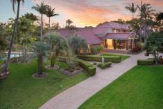 38 Ridley Rd Bridgeman Downs QLD 4035 A Private Retreat with Resort Facilities A true sense of arrival is experienced upon approaching the residence via a long drive bordered by manicured lawns and majestic trees. Set well back and concealed from neighbouring properties by the lush foliage, the expansive residence takes full advantage of its generous grounds and North-East orientation. An impressive formal entry showcases a glass feature wall and a stunning integrated aquarium with vibrant tropical fish. Once inside, an extremely flexible and livable floor plan is offered with an extensive choice of living and entertaining areas and ample accommodation for friends, family and guests. To the left of the foyer is a spacious formal lounge room. A gas fire place with stone mantle is the focal point of the room. The lounge is adjoined by a generous formal dining room which showcases a beautiful chandelier. Both rooms boast large windows which provide an abundance of natural light and views of the gardens and swimming pool. To the right of the foyer is the casual dining and family room. It opens through large sliding doors to an outdoor entertaining terrace which overlooks the leafy grounds. The terrace features a gabled roof and enjoys a perfect North-East orientation, making it an ideal spot for year round entertaining and relaxing. The well-appointed kitchen is centrally located between the formal and informal living areas. It comprises a full complement of stainless steel appliances, including Ilve oven and Miele combi-oven, dishwasher, integrated coffee machine and plate warmer. Neutral tones have been selected for the cabinetry which also feature soft-close mechanism and quartz stone bench tops. The kitchen also boasts a huge butler’s pantry with sink, open shelving and integrated food scales. Adjacent the kitchen is a sunken recreation/TV room. Oversized timber doors slide open to the outdoors and a pathway leading to a beautiful gazebo which overlooks the pool and the tennis court beyond. The main house offers four bedrooms in total, with the generous master bedroom enjoying a private position at the end of the hall. More like a luxury hotel suite, the master is distinguished by a glamorous open plan ensuite, spacious His & Her walk-in-robes and a private terrace with tranquil water-feature. A second bedroom is located on the ground level and is serviced by the stylish family bathroom. Two additional bedrooms are located on the upper level of the home. These bedrooms are separated by a casual lounge/retreat. One bedroom can function as a second master, having a huge walk-in-robe, large ensuite with spa bath and north facing terrace. The other bedroom also enjoys a north-east aspect, ensuite and has a built-in-robe. A state-of-the-art home theatre room is tucked away on the ground level. It features a massive viewing screen, surround sound and electric block out curtains. The expansive grounds offer resort style facilities including a North-South tennis court, 15m swimming pool, gazebos and a beautiful summer house. The north-facing summer house is enormous and can accommodate the most elaborate of parties. Oversized, frameless glass door retract to open the entire room to the outdoors. It features shower and toilet facilities and a fully equipped kitchen with gas BBQ, teppanyaki plate, dishwasher, fridge and sinks. One of the most versatile features of the property is a fully self-contained guest house located to the rear of the main residence. Ideal as a granny-flat, guest/nanny quarters or for adult children living at home; it comprises a bedroom, bathroom, kitchenette and living area. It is adjoined by a huge garage with space for approximately 6 cars. This space is ideal for use as a large work shop or for car and boat enthusiasts. It may also be further developed for additional living space. Seldom does a property claiming such significant land size, privacy and spectacular entertaining facilities become available this close to the CBD. This is an incredible opportunity to secure a dream home and an exclusive lifestyle. Features Grounds: 7023m2 of Private, Fully Landscaped Grounds Ideal North-East Orientation Floodlit North-South Tennis Court Sparkling Swimming Pool (approx. 15m) Enormous Summer House with full kitchen and bathroom facilities Pool and Tennis Court Gazebos Main House: 4 Bedrooms & 4 Bathrooms (3 ensuites) Formal Entry with Aquarium Formal Lounge (Fire Place) & Dining Room Casual Family & Meals Area Concealed Home Office North-East Terrace Sunken Recreation/TV Room Home Theatre Room 2 Car Lock up Garage plus additional Carport Villa House: Fully Self- Contained Living Quarters 1 x Bed 1 x Bathroom 6 x Car Accommodation (opportunity for further development) Additional Features Ducted Air and Ceiling Fans Piped Music throughout including Outdoors Back to Base Security Security Screens Irrigation System