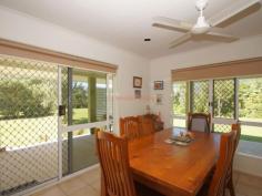 34 Thomas Ct Bulgun QLD 4854 $450,000 SPACIOUS LIVING ON LARGE BLOCK BORDERING CREEK This well presented 3 bedroom home has a lot to offer in the way of serene surroundings as well as proximity to the centre of Tully, approximately 10 minutes drive. The block is approx. 8002m2 in size. Tiled throughout and with verandahs around three sides for shade from Easterly and Westerly sun, this home has a coolness even on warm days. The sleek, modern kitchen accomodates barstools and is a great size for those who love to cook and entertain. A viewing window through to the living room ties both spaces together and makes sure that light as well as conversation flow through to the living space. Views from the dining table are that of beautiful green rainforest foliage and distant mountain ranges. Adjacent to the kitchen, the large office space has access to the back patio. 3 bedrooms all feature built-ins with mirrored sliding doors. A vast amount of storage is offered in this home with floor-to-ceiling cupboards running the length of the hall. The bathroom offers a shower and single vanity with separate toilet adjacent. The laundry is a great feature being so large in size and boasting an internal clothesline for those grey Tully days. The double bay remote operated roller door garage is a great asset to the property featuring a small kitchenette and a drive through roller door to the backyard as well as the ability to park 4 cars comfortably. The driveway has ample facilities for off-street parking and is well maintained, just like the gardens . The back patio has a bench and sink configuation which is currently being used for gardening purposes, but could easily serve as part of an outdoor kitchen if needed. The back yard also features a good size garden shed for all your gardening and hobby storage solutions. This house has a lot to offer and is definitely worth a look. For any enquiries do not hesitate contacting one of our friendly sales team at LJ Hooker Tully (07) 4068 1100 Property Snapshot Property Type: House Construction: Concrete Block Zoning: RESIDENTIAL (RURAL) Land Area: 8,002 m2 Features: Built-In-Robes Established Gardens Garden Shed Outdoor Living Remote Control Garaging Renovated Security Screens Storage Undercover Entertainment Area Verandah