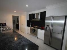 12-14 Paine Pl Kooralbyn QLD 4285 $469,000 ABSOLUTELY STUNNING For those who want the best this is a must to inspect. When you walk in the door you will be impressed by the sheer quality of this home. At one end of the house you have a double size master bedroom with WIR and ensuite with spa bath, a study and a purpose built home theatre room. At the othe end you have 3 double bedrooms, luxurious bathroom, formal dining room or extra office space, laundry and double lock up garage with storage areas and remote access. You will also delight in the gourmet kitchen which adjoins the large lounge and dining area overlooking the inground lap pool and large rear yard with fencing and 2 yards for horses and other animals. Words cannot fully explain the feeling you get from such an impressive home, it has to be inspected to fully appreciate it. Property Snapshot Property Type: House Construction: Brick House Size: 260.00 m2 Land Area: 7,124 m2 Features: Built-In-Robes Ceiling Fans Close to schools Dining Room Dishwasher Ensuite Established Gardens Family Room Fenced Back Yard Formal Dining Room Fully Fenced Yard Garden Shed Gas In-Ground Pool Internal Access via Garage Landscaped Gardens Lounge Outdoor Living Parents Retreat Pool Remote Control Garaging Rumpus Room Security Screens Storage Study Walk-In-Robes