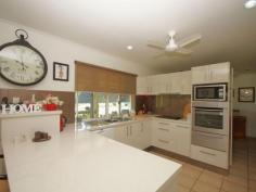 34 Thomas Ct Bulgun QLD 4854 $450,000 SPACIOUS LIVING ON LARGE BLOCK BORDERING CREEK This well presented 3 bedroom home has a lot to offer in the way of serene surroundings as well as proximity to the centre of Tully, approximately 10 minutes drive. The block is approx. 8002m2 in size. Tiled throughout and with verandahs around three sides for shade from Easterly and Westerly sun, this home has a coolness even on warm days. The sleek, modern kitchen accomodates barstools and is a great size for those who love to cook and entertain. A viewing window through to the living room ties both spaces together and makes sure that light as well as conversation flow through to the living space. Views from the dining table are that of beautiful green rainforest foliage and distant mountain ranges. Adjacent to the kitchen, the large office space has access to the back patio. 3 bedrooms all feature built-ins with mirrored sliding doors. A vast amount of storage is offered in this home with floor-to-ceiling cupboards running the length of the hall. The bathroom offers a shower and single vanity with separate toilet adjacent. The laundry is a great feature being so large in size and boasting an internal clothesline for those grey Tully days. The double bay remote operated roller door garage is a great asset to the property featuring a small kitchenette and a drive through roller door to the backyard as well as the ability to park 4 cars comfortably. The driveway has ample facilities for off-street parking and is well maintained, just like the gardens . The back patio has a bench and sink configuation which is currently being used for gardening purposes, but could easily serve as part of an outdoor kitchen if needed. The back yard also features a good size garden shed for all your gardening and hobby storage solutions. This house has a lot to offer and is definitely worth a look. For any enquiries do not hesitate contacting one of our friendly sales team at LJ Hooker Tully (07) 4068 1100 Property Snapshot Property Type: House Construction: Concrete Block Zoning: RESIDENTIAL (RURAL) Land Area: 8,002 m2 Features: Built-In-Robes Established Gardens Garden Shed Outdoor Living Remote Control Garaging Renovated Security Screens Storage Undercover Entertainment Area Verandah