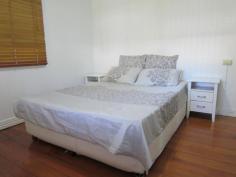 101 Pine Mountain Rd Brassall QLD 4305 379,000 2312m2 (Over half an acre) of fully fenced, shaded tree, spacious bliss located close to the CBD yet only a stroll away from shops, beauty, takeaway, IGA, bus stop, schools and all that you ever need. Be on the Warrego Highway in only a few turns of the steering wheel and when you finish with the hustle n bustle of the outside world…come home and relax in your massive, scenic rear yard paradise! Bring the dogs, trucks, trailers, motorhome or maybe even a granny flat to plonk on this sprawling piece of Australia. The decorative front fence has just had a fresh lick of paint, as has both the internal and external areas of the home. A carport sits at the ready to park the pride and joy beneath and up to 3 small cars can easily park in under the home on the concreted slab, where you will also find the laundry area. The covered front veranda is the place to sit and watch the world pass by and inside you will find timber flooring mostly thoughout, 2 large bedrooms (1 with an adjoining sleepout area that would make a perfect ensuite/walk in robe conversion), a large air conditioned formal dining room (that would easily convert into a 3rd bedroom), an adjoining lounge room that opens into another sleepout that also extends into the supersized dining/family room that features almost a wall of beautiful stained coloured glass windows. A separate study leads out from the dining/family room area, or if you would prefer your laundry to be upstairs…then it’s the place for it! The country styled kitchen is the perfect theme for the surrounding timber tongue & groove walls & ceiling, plus the decorative fretwork. A 12 month old oven takes care of business and you have plenty of room for all you need to do within the kitchen thanks to the large island bench. The bathroom definitely does the job required of it, roof insulation keeps the climate just the way you like it, high ceilings are everyone's favorite, the roof guttering has been upgraded, as has the sewer lines and storm water exit pipes. A garden shed is on hand for the lawn and garden equipment and if that needs servicing….simply walk down to the local mower shop! Features Study Floorboards Shed Fully Fenced