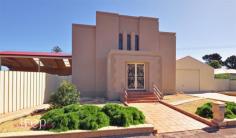 41 Donaldson Terrace Whyalla SA 5600 $750,000 A SLICE OF HEAVEN - REDUCED House - Property ID: 683540 Situated on a 1570m2 corner block this unique residence gives a rare opportunity to the purchaser. Something Old The original building served Whyalla as a Methodist Church from 1940 to 1971 and was lovingly converted to a two story residence in the mid 90's A tiled entrance with magnificent double leadlight doors leads to the open plan living / dining and family area with the WOW factor. Views up to mezzanine level and stunning high raked ceilings with cathedral type leadlight windows will take your breath away. Lounge area includes built in furniture with the area serviced by gas heater and split system air conditioner. Off the living room is the well equipped timber kitchen with adjacent meals that keeps to the theme of the home and features leadlight windows and a doors leading to the large enclose carport. The kitchen has gas cooking and dishwasher. The mezzanine level has three bedrooms. The 2nd bedroom has a walk through robe leading to the two way bathroom with shower, bath and toilet. The other two bedrooms offer quality built in robes and stunning ceilings, windows and fixtures. This level is serviced by ducted evaporative cooling. Quality fixtures and fittings are throughout with leadlight light fixtures a feature of the home. Something New Step into the 2012 extension where the main living area is tiled with high ceilings and huge proportions. The new main bedroom has a walk in wardrobe or dressing room and modern ensuite bathroom with shower, double basins and toilet. Bedroom 5 has built in robes. A laundry and third new, modern bathroom finishes the extended area. The extension windows and doors have been double glazed for energy efficiency. Step out of the new living area to a large tiled outdoor area covered with new gabled veranda with ceiling fans. Outside the property offers a number of outbuildings including a gazebo with kitchenette, 40x20 shed with lane access, 50 x 20 shed with double electric roller doors to street of which half is lined. The home is serviced by instant hot water system and has a solar panel system installed. Inspection by appointment. C/Rates $2041.55