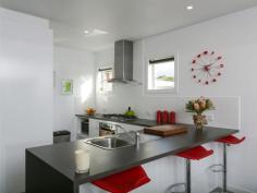 1/20 Market St Eaglehawk VIC 3556 Upmarket on Market There's bound to be a lot of frenetic activity on August 15 when this low-maintenance property goes to auction. Ideal for investors, first-home buyers or retirees, it has all the hallmarks of a modern inner-city pad without city rates, etcetera. You can walk around the corner to the railway station, over the bridge to the shops and Star Cinema and across the road to the tennis courts where apparently they have fabulous afternoon teas. The owners love the neighbourhood and the crown land outlook next door. The angled roofline and brick and rendered faade, give the dwelling a contemporary look. Two bedrooms, two bathrooms, an open-plan kitchen, dining and living area, European laundry and separate toilet are all wrapped up in brilliant white walls and ceilings with just a splash of colour in the tastefully decorated bathrooms, the coffee-coloured porcelain tiled floors and the luxurious charcoal carpet in the bedrooms and living area. Clerestory windows in the living area draw in light and sunshine while giving privacy, while north-facing windows with a sliding door opening to undercover entertaining, shower the kitchen and meals area with light. Stainless steel gas appliances combine with a sleek Bosch dishwasher in the kitchen and there's a handy breakfast bar for quick snacks. The main bedroom has a reverse-cycle split-system, (one of two) ceiling fan, built-in wardrobes and a 1200mm x 900mm shower with a rainfall showerhead in the en suite. A similar showerhead is also in the three-piece bathroom. Built-in wardrobes and a ceiling fan are in the second bedroom. A single garage with a remote control roller door, open shelving, internal and backyard access, completes the package. The outside is concreted with a rainwater tank plumbed to the toilet. Be sure to inspect soon.