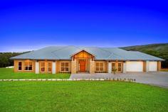 102 Baileys Ln Kurrajong Hills NSW 2758 $1,950,000 One of a Kind This stunning trophy property is impressive during the day and magical at night. It is situated in a quiet cul-de-sac in a prestige street of the breathtaking Kurrajong Hills only 5 minutes from the quaint caf's of Kurrajong Village. This almost brand new custom designed and built home is only 3 months old and is set on 10 picturesque acres, this home has been built to the highest standard. With quality inclusions and a timeless, spacious design this home oozes sophistication. As soon as you enter you realise that this home is like no other. With its high ceilings, impressive stone fireplace, large panelled glass windows to capture the undulating views, the amazing al-fresco area with its own fireplace and raked ceilings, you will never want to leave. Set on 5 cleared and 5 bush acres, this property's bottom boundary is the stunning crystal clear flowing waters of Little Wheeny Creek. Quality features include; • Large light filled combined casual dining and lounge room • Spacious media room or formal lounge room • 4 double sized bedrooms all with quality BIR's • Expansive main bedroom with a WIR sure to impress • Impressive Main bathroom with free standing bath and rain shower • Ensuite access from the 4th guest bedroom • Custom made polyurethane bathroom cabinets with stone bench tops • Luxurious wool carpet underfoot • Indulgent Ensuite to main bedroom with freestanding bath in front of large panelled glass window. Perfect to soak away in whilst admiring the beauty of the rolling hills • Large triple car garage with plenty of space forstorage and work bench. • Quality kitchen and butlers pantry with stone bench tops and quality European appliances • Ducted air conditioning, security alarmed, an abundance of internal storage. • Enviable laundry with stone bench tops, plenty of bench space and cupboards • Data networked in all bedrooms and both lounge areas • Plenty of concreted space for parking the cars or toys
