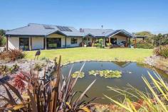 293 Stevens Rd Witchcliffe WA 6286 $1,595,000 Luxurious Estate 4 3 16 15 acre (approx) This magnificent homestead is set on 14 acres of undulating parkland right in the heart of the Margaret River wine region. The custom designed home makes the most of the north facing aspect and has been thoughtfully planned to make best use of its solar passive aspect. Designed in two living wings with a connecting foyer, the enormous open plan living/kitchen/dining wing comprises a modern well appointed kitchen, expansive sandstone tiled flooring and view capturing doors which open onto the large covered outdoor deck that soaks in the tranquil atmosphere of the landscaped gardens complete with lily pond. Conduct business from home with ease as there is a separate study located adjacent to the entrance door. The bedroom wing is cleverly designed with three double size bedrooms surrounding a second loungeroom that also overlooks the gardens and opens directly onto the north facing verandah. The main bedroom has the indulgence of a walk through robe that leads into a sumptuous ensuite. A second bathroom and separate WC (complete with exterior vanity) is located closer to the remaining bedrooms. Modern stylish tiling, carpeting and fixtures and fittings are evident throughout the entire home and provide a sense of luxury and comfort. If this luxurious home isn't enough for the family, there is a modest cottage located in the valley of the property. Nestled amongst trees, this accommodation would be the ideal pad for the teenager or extended family or rent out to paying tenants, as it consists of a bedroom, open plan living and a bathroom. A spacious elevated deck leading out from the living area overlooks lush lawns and a picturesque spring fed 50m x 40m x 3m deep dam. A large 17.5m x 7.5m powered colourbond shed with concrete floor to two bays is situated between the main house and cottage and provides ample space to store all of the equipment. An area of this shed has been decked out into a games room/living quarters, providing even more space for the kids and extended family. Abutting Leeuwin Estate and neighbouring Voyager Estate wineries, only 9 kilometres from the Margaret River townsite and only 6 kilometres from the coast, live in luxury on the land knowing that the conveniences of town are only a short drive away and the beauty of the region is all at your doorstep.