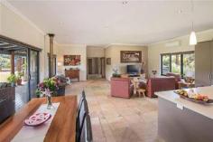293 Stevens Rd Witchcliffe WA 6286 $1,595,000 Luxurious Estate 4 3 16 15 acre (approx) This magnificent homestead is set on 14 acres of undulating parkland right in the heart of the Margaret River wine region. The custom designed home makes the most of the north facing aspect and has been thoughtfully planned to make best use of its solar passive aspect. Designed in two living wings with a connecting foyer, the enormous open plan living/kitchen/dining wing comprises a modern well appointed kitchen, expansive sandstone tiled flooring and view capturing doors which open onto the large covered outdoor deck that soaks in the tranquil atmosphere of the landscaped gardens complete with lily pond. Conduct business from home with ease as there is a separate study located adjacent to the entrance door. The bedroom wing is cleverly designed with three double size bedrooms surrounding a second loungeroom that also overlooks the gardens and opens directly onto the north facing verandah. The main bedroom has the indulgence of a walk through robe that leads into a sumptuous ensuite. A second bathroom and separate WC (complete with exterior vanity) is located closer to the remaining bedrooms. Modern stylish tiling, carpeting and fixtures and fittings are evident throughout the entire home and provide a sense of luxury and comfort. If this luxurious home isn't enough for the family, there is a modest cottage located in the valley of the property. Nestled amongst trees, this accommodation would be the ideal pad for the teenager or extended family or rent out to paying tenants, as it consists of a bedroom, open plan living and a bathroom. A spacious elevated deck leading out from the living area overlooks lush lawns and a picturesque spring fed 50m x 40m x 3m deep dam. A large 17.5m x 7.5m powered colourbond shed with concrete floor to two bays is situated between the main house and cottage and provides ample space to store all of the equipment. An area of this shed has been decked out into a games room/living quarters, providing even more space for the kids and extended family. Abutting Leeuwin Estate and neighbouring Voyager Estate wineries, only 9 kilometres from the Margaret River townsite and only 6 kilometres from the coast, live in luxury on the land knowing that the conveniences of town are only a short drive away and the beauty of the region is all at your doorstep.