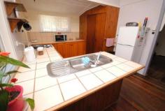 24 Rose St Kilkivan QLD 4600 $150,000 Looking for space? At an affordable price tag? This one ticks so many boxes. Large 1342 m2 level block. Mostly fenced. Solid large old timber home in good repair. 4 Bedrooms, plus on office and a sleep-out. Polished timber floors through out. Renovated bathroom with separate bath and shower. Good sized kitchen with open plan dining area. Separate front sunroom or second dining room. Double lock up colour bond garage and lock up timber workshop/shed. Town water, tank water and a good bore. Walk around the corner to the local shops and state school. The main street of the town is close by. With a couple of cafe's, post office, butcher, hair dresser, library, butcher, pup and antique store to name a few. the owners have decided to liquidate this property from their holdings and price it to sell. Inspections will not disappoint. Other features: Close to Schools,Close to Shops,Garden,Secure Parking Property Details Elders Property ID: 9285165 4 bedrooms 1 bathrooms 2 car parks Land Area 1342 square metres Double garage