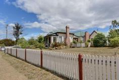 120 Arthur Hwy Dunalley TAS 7177 $249,000 Picture Perfect Classic 1870's weatherboard cottage has been renovated to compliment, retain and enhance its many charming original features. Offering 3 bedrooms this home is entered via a picture perfect picket fence, along a brick pathway, through the rose garden and onto the front veranda. A welcoming spacious hallway is presented with polished timber floorboards and access to two of the bedrooms. These double bedrooms include features such as antique light fittings, fire places, ornate cornice and ceiling roses. This is just a taste of some of the character filled surprises this unique cottage has to offer. At the end of the entry hall the galley style Tasmanian Oak kitchen awaits with adjoining dining that flows through French doors onto a timber deck, just perfect for al fresco entertainment. Step up to a separate lounge room, one may choose the ambiance of the wood heater or the convenience of modern heating. The original Dunalley post office hosts the third bedroom but also lends itself to many uses such as a magnificent master suite, games room, study, or extend to current lounge, there really are so many options. The superb bathroom will impress most on first inspection not just on size alone it offers quality fixtures including a claw foot bath as the centerpiece, a separate shower, large vanity, ample storage and linen press. The rear of the property presents another private entertaining area, second toilet, laundry, workshop and more storage options adding even more value to this charming home. Enhanced by cottage gardens, established fruit trees, olive trees, rose bed and two single garages this warm and welcoming home reaped in history is on 2 titles totaling 1725m2, has no immediate neighbours, enjoys water glimpses over Blackman Bay and is only a short stroll to the school, shops and cafes. An absolute must on the inspection list. General Features Property Type: House Bedrooms: 3 Bathrooms: 1