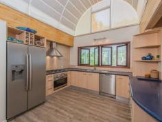 75-77 Tramican Street Point Lookout QLD 4183 $2,300,000 Both blocks are a total of 1,800m2 and have wonderful beach, bush and ocean views. The large architecturally designed house has a two car lock up garage at street level which links to the house with a timber walkway. The garage building has a large loft area - perfect for a craft room, office or even a separate studio bedroom and lockable storage areas underneath. The main house has two levels with all living areas on the top level. There is a formal lounge area on entry, large open plan kitchen with walk in pantry plus formal dining - all opening onto a covered deck. There are two bedrooms and a bathroom on this level also. The bottom level has three more bedrooms including the master bedroom with walk in robe and en suite bathroom, a second bedroom also has an en suite with spa bath and there is a small bunkroom The separate laundry with large storage area (perfect for a wine cellar) has direct access to the garden.