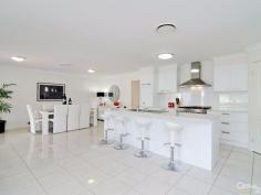 7 Oaklands Pl Upper Kedron QLD 4055 DOWNSIZE WITHOUT COMPROMISING ON STYLE & SOPHISTICATION. Crafted to deliver a living experience of a premium standard, those lucky enough to call this place home will delight in a zoned single-level layout dressed with gourmet two-pack kitchen with quality stainless steel appliances and Cesarstone benchtops, 9ft high ceilings and ducted air-conditioning. What's also certain to strike the right chord amongst the growing family is the idyllic blend of living spaces, along with the manner in which all bedrooms are thoughtfully nestled in private sections of the home. A large Master bedroom (with luxurious ensuite and walk-in robe) stands alone at the front of the home, with the children's quarters tucked away on a separate wing with a central family bathroom and media room. Class and elegance defines the striking formal lounge and dining arrangement, which extends onto a private, covered entertaining area, ideal for serving canapés and pre-dinner drinks during those formal gatherings. Stunning open-plan living is therefore left to steal the show at the top of the layout, impressing with its excellent sense of space and low maintenance lifestyle. Surrounded by quality homes and set amongst meticulously maintained, low maintenance gardens this is the perfect sanctuary. A true statement in luxury living and innovative contemporary design and a must inspect. PROPERTY DETAILS UNDER CONTRACT ID: 369585 Land Area: 541 m²