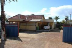 39 Spear St Cunderdin WA 6407 Own A Home Of Your Own This home has everything that you need plus a few extra's. This neat and tidy 2 bedroom with a sleep out, 1 bathroom home will delight you and at an affordable price. Your fibro/weatherboard and tile home has a side carport which gives you easy access into a covered enclosed front patio area and then right to your front door. All safe and secure and keeps you out of the elements when you are unpacking your groceries. Inside the home you have an open plan kitchen and dining are with a heater/cooler air conditioner in the wall. The kitchen has a gas stove and sufficient cupboard and bench space. The lounge comes off the main dining area which has a split system air conditioner and room for your lounge and large screen television. Your master bedroom also comes off the dining area, this room is a good size and has plenty of natural light. To the rear of the home is your bathroom, with a shower, vanity and toilet. The rear verandah has been enclosed so you have another sitting area, and second bedroom. Here are your extras, the home has an extension off the home which makes an ideal sun room, study area or craft room. The home has a large roller door cement floored workshop/garage, so you have room for your trailer, caravan and workshop tools. The current owner has installed solar panels to keep you power bills down, you have a solar hot water system for your hot water. All in all a great package, great home, shed on a 986 square meter corner block. We look forward to showing you this property. Property Details Elders Property ID: 10310736 2 bedrooms 1 bathrooms 6 car parks Land Area 986 square metres Car Parks: 3 Double garage Single carport