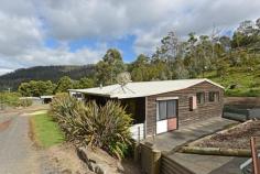 23 Handsome Caves Rd Magra TAS 7140 $175,000 Life in the Country (but pretty handy to town) The options are plenty at this exciting property that is located just a few minutes out of New Norfolk. Located in a very private setting and offering a good mix of pasture and bush and a very pretty dam, there is a lot to like here. Lots of sheds, a bush sleep-out and a very comfortable temporary dwelling (really a small house) it's just perfect as a weekender or as a base to stay while you create and enjoy your bushland oasis. Attractively landscaped gardens and with good access tracks and a lifetimes supply of firewood at hand, this really is a very appealing option. A short bushwalk from this block delivers you to very attractive sandstone outcroppings and the interesting, sandstone Handsome Caves. Sit back on the deck, relax in the outdoor spa with a glass of wine and simply enjoy the serenity. Life in the bush - it doesn't get much better than this. General Features Property Type: House Bedrooms: 1 Bathrooms: 1 Land Size: 16.22 Hectares