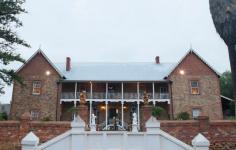 24 Grey St, York WA 6302 Faversham House is considered one of the most beautiful properties in Western Australia and is one of Australia’s oldest privately owned country homes. The residence sits at the end of a gated drive and is set on 1.7 hectares of spectacular heritage parkland gardens and vineyards overlooking Mt Brown. Established by the Monger family in 1840 the property has a fascinating history which includes being gifted to the Australian Government to assist with the war effort in 1941. The house was then used by the Red Cross as a hospital until the 1950’s. The earliest parts of Faversham House date from 1840, and early renovations include a spacious drawing room with fireplace and a sizeable dining hall. It has been in the hands of the current owners since 2004 and boasts interiors restored with Georgian and Victorian features. The gardens have undergone considerable landscaping and feature additions such as the “secret garden and amphitheatre”. With its elegant romantic setting this impressive heritage mansion currently operates as a country house wedding venue, as well as a unique location for corporate functions, which the current owners say generate “good income”. It has hosted over 150 weddings during the past 10 years, as well as many conferences and company meetings for national corporations, government departments and universities, many of which are repeat bookings. 14 bedrooms all with air conditioning, 7 of which are located on the top floor and are extremely spacious accommodating both a kingsize bed and sitting area. Six further bedrooms are set around a pretty courtyard with pergola adjacent to the main building. Two of these have been superbly upgraded in recent years. – Spacious front balcony with fabulous views. – Impressive grounds covering over 5 acres, including established gardens, mature trees, fruit trees and expansive lawns. – Peace and tranquillity whilst still being within walking distance of town. – Listed with the National Trust and registered on the National Estate of the Australian Heritage Commission. – Permission for private residence, private with income or commercial (function centre, B&B, art gallery, restaurant etc). The house is perfect as an idyllic private residence, however the unique setting is ideal for private functions such as company seminars, boutique accommodation or a wedding venue. Situated in the heart of York with an easy walk to the nearby historic attractions and restaurants in town. 75 minutes drive from Perth.