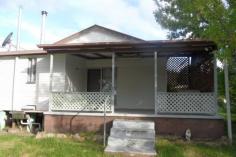 10 Aplin Street Stanthorpe QLD 4380 Easy stroll to Stanthorpe's main street, schools, shop etc - all town services ---set on generous 1012m2 land - low set timber home with 2 bedrooms + sleep out, separate lounge with gas heater, good size dining/kitchen area - there is a combustion stove PLUS electric stove and plenty of good cupboard space too! The bathroom has a separate toilet. There is a covered casual area at the rear - ideal for all year use and more space! The property also has a single lock up garage plus garden shed. Currently there is an excellent long term tenant on a month to month lease but happy to continue if suits an investor! Rental is $210 per week. Great buy on today's market to live in or as investment and a keen seller wants this sold now! So what are you waiting for? Call Anne Lindsay on 0418 737309. Features Smoke Alarms Undercover outdoor area Safety Switch