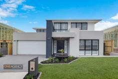 26 Prospect Avenue, Glenmore Park, NSW 2745 Just completed and constructed in the dress circle community that is Mulgoa Rise is this unique and beautifully designed residence by Endota Homes. Showcasing meticulous attention to detail, stunning design ethos and quality craftsmanship throughout, the home has a contemporary yet timeless appeal. Built to the highest standard evidenced by the quality of the fittings and fixtures, this home exudes sophistication. > The first home to be completed in the street enhanced with sweeping views of the Blue Mountains from the rear of the property > Built over two levels with the lower level dedicated to executive, family living and entertaining > Five bedrooms including a guest bedroom and ensuite privately set, the master bedroom is of a grand size and is complemented by the spacious walk-in robe and ensuite > The kitchen and butlers pantry would be the envy of any professional chef or enthusiastic entertainer featuring 900mm gas cooktop and oven, 40mm stone benchtops, extensive island bench, soft close drawers and cabinets > Striking bathroom with Herringbone tiles, semi-frameless shower screens and free standing bath > Multiple living zones include casual living and dining rooms, theatre and rumpus room > High ceilings, Victorian Ash stained stairs and glass balustrade > Custom pendant feature lighting in the dining area plus feature pendant lighting displays > Oversized alfresco area, accessed via sliding doors and large window servery, merbau hardwood benchtop and seating, BBQ and range hood, ceiling fan and gas point > Mud area with custom seating, shoe drawer, large under stair storage > Double remote garage, ducted air-conditioning, water tank and alarm