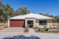 25 Peaceful Ln, Gidgegannup WA 6083 $699,000 Property Details Block Size 5 acres Zoning Rural Res Shire Rates $2,325 Description You can’t help but wonder why you would want to build when you can skip past all the stress and go straight to enjoying your brand new home. Built in 2016, this 4 bedroom 2 bathroom Redink home is superbly spacious with 3 separate living areas and large bedrooms to accommodate a growing family. Nestled on a 5-acre parkland cleared and pasture battle axe block, a fantastic semi-rural lifestyle awaits you in this friendly neighbourhood. 4 bedrooms 2 bathrooms 2016 Redink family home Expansive open plan living Deluxe theatre + activity Huge master w/ WIR + ens Large jnr bedrooms w/ BIR Gently elevated alfresco Parkland cleared + pasture 5-ac battle axe, rural view Friendly community locn Tucked away behind parkland timber, this battle-axe property is set in a rural pocket that is convenient for day-to-day life. A portico extends from the front of the home, welcoming you into the wide entry. The master suite is set to your right, offering sought-after separation from both the junior wing and living hub. The expansive space features a beautiful rural outlook, large walk-in robe and open ensuite. The ensuite is finished with dark décor and suggests sophistication and indulgence with double vanities, a double shower, large bath and separate wc. From the main entry, timber look flooring and high ceilings continue throughout the home, as does ducted reverse cycle air conditioning for optimal comfort all year round. Double doors open into the home theatre that offers itself as your new go-to spot for watching the latest releases. The hallway opens to unveil the spacious open plan living hub in the heart of the home. A long breakfast bar connects the kitchen to the lounge and dining whilst creating a convivial spot for casual meals and chit-chat when entertaining family and friends. Complete with a full suite of stainless steel appliances that include a 5-burner gas cooktop, wall-mounted electric oven, grill and dishwasher, it also boasts a huge walk-in pantry and handy IT recess. Sliding doors continue to the adjoining entertaining alfresco. Gently elevated over the rural vista and pasture beyond, this is a fantastic space for casual BBQ dinners or celebrations with friends and family. Glow in the dark quartz in the exposed aggregate concrete creates an otherworldly atmosphere at night. The junior wing offers fantastic separation for growing families, plus a third living area with a versatile activity space that could be used for kids to play, teens to study or young adults to retreat to. The three junior bedrooms are each a large queen size with mirrored built-in robes, making them rival some modern masters. The 5-acre property is part parkland clear and part pasture and offers itself as a blank canvas for your future vision. With plenty of room for livestock, a big shed or pool, you can establish it however you see fit! Set in the premium location of West Gidgegannup, this fantastic family home is in a friendly semi-rural neighbourhood. It’s an easy drive into the bustling Midland CBD and short commute to the endless delights of the Swan Valley for fun come the weekend. To arrange an inspection of this property or for friendly and honest assistance with any of your real estate needs call Mr Happy – Ross Webster – 0407 387 004.