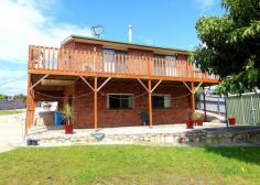 20 Cherrywood Dr Scamander TAS 7215 $365,000 (1817m2) This home sits within walking distance of the beaches, river, shops, hotel, post office, fishing, surfing and most of Scamander’s facilities. Upstairs offers 3 good sized bedrooms all with built-ins and the main with an ensuite, walk-in-robe, ocean views and deck access. The living and dining area flow into each other and offers great space and deck access from both the dining and living areas. The main bathroom is spacious and has a spa bath, separate shower and timber vanity. Stairs lead to a very large rumpus/ games room or 4th bedroom. This area has its own toilet and vanity, there are also 2 other utility rooms that run off the rumpus room. This area would be perfect for a teenager retreat or guest area. With some work it could be self-contained as it has its own access. There is also a double garage with carport at the rear of the property. All this sits on a large 1817m2 block with great established fruit trees and plenty of space for your boat or caravan. Good value here!