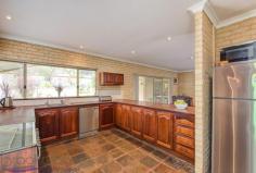 360 Summit Road, Mundaring, WA 6073 $719,000 Everything is in place to ensure you make the most of life on this 1-acre property. A wonderful, large 4 bedroom, 2 bathroom home with open plan living, generous bedrooms, a spectacular high-gabled paved alfresco with views of lawn and formal gardens and a fabulous 3-phase powered workshop. 4 bedrooms 2 bathrooms 1996-built brick and iron Vast open kitchen, living Large sunken loungeroom Sunny, airy studio / study Gorgeous jarrah benchtops Spectacular alfresco living Scheme, tank, bore water 1-acre, 3 phase workshop Minutes from Mundaring Generosity – room to move, play, grow, learn and work – infuses this home. Ideally placed, in every way, moments from the Mundaring Village, within easy reach of transport links, a choice of schools and arterial roads, this elegant 4 bedroom, 2 bathroom home, sits in a landscaped garden with a backdrop of gorgeous native vegetation and is sure to suit your family now and into the future. A circular drive surrounds a planting of citrus, herbs and an ornamental pear tree to create a striking first encounter. The home sits elegantly at the centre of the property – back from the road and elevated. An enclosed carport with roller door is arranged to one side of the home. A stain-glassed entry opens to a sunken lounge with views of rose bushes and the native landscape. A wonderfully restful space, generous proportions and plush carpets, perfect space for quite evenings at home or formal entertaining. Step up from the lounge room to the bright studio space. With French doors to the northern verandah and windows to the west, this room is an ideal workspace for artists and crafters. The spacious master suite, features a walk in robe, patio access, and a big, bright ensuite with a storage alcove. An impressive open plan kitchen / family room is incredibly comfortable and inviting thanks to warm-toned slate floors and gorgeous solid jarrah bench tops. A slow combustion fire, ceiling fan and high ceilings reinforce the feeling that this is a space designed to be the centre of family life. The kitchen contains a free standing 900mm Emilia oven, dishwasher, walk-in pantry and ample storage. The wide bench top forms a long breakfast bar and large windows wrap the corner of the room to deliver views of the gorgeous surrounds. Along the eastern side of the home is an impressive 9.2m x 6m paved, alfresco terrace. Covered by a high-gabled roof, the views of the garden, lawn and curved sandstone walls produce a restful and beguiling outdoor living area. The open plan family room leads to the junior wing, which includes two large bedrooms with built-in wardrobes, that offer views to the alfresco terrace and a third bedroom or study room. A large family bathroom with bathtub, separate shower and vanity is arranged with a separate W.C adjoining the walk-through laundry. Follow the lawn, past the wisteria and along the sandstone garden walls to reach the large, shed with 3-phase power. Vehicle access and a turning circle make for a practical workshop, double sliding doors, a side entrance and a bathroom with separate septic system ensure this approximately 15 m x 8 m space is adaptable to many uses. Beyond the property’s rear boundary is a wildlife corridor and bridle trail. A perfect balance of garden, bushland views and outdoor living, the landscaped gardens host established fruit trees, ornamental blossom trees and rose bushes. Set against a background of native vegetation, the effect is enchanting and wonderfully Australian. Maintaining the garden is made easier through the use of a reticulated bore and 43K litre tank. Generous, bold, yet unpretentious, the spacious home offers stylish living. Solid family-ready fixtures and high end finishes give a sense of enduring quality. Solar panels, established gardens, ducted evaporative cooling, bore water and proximity to Mundaring Village support a sustainable lifestyle for years to come.