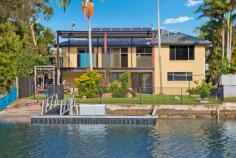 50 Jacaranda Avenue Two Heads West NSW 2485 Waterfront Home with Pontoon and Sandy Beach/ Boat Ramp Defined by a wonderful sense of understated waterfront location, this well presented home reveals a family environment as stylish as it is comfortable. It's enviably positioned within a level walk of cafes, shopping choices and a reserve next door. Keep the guests/teenagers or parents downstairs as it's a perfect get away or private work space. - Open plan design creates flexible living and dining spaces to enjoy sunrise and sunsets - Sliding doors open to all-weather alfresco sun washed entertaining spaces - Peaceful easy care back yard lined with scattered trees and gardens, pontoon and boat ramp - Granite/two pack finished kitchen, large pantry, gas stove top cooking and bonus water views - Three upper level bedrooms all have built in wardrobes, plus ground floor fourth with separate lounge area , bathroom and kitchenette - Master boasts a large window with water views and air-conditioning - Timber flooring upstairs, air conditioned lounge/dining - Downstairs easy care epoxy floor effect over concrete floors, bathroom with large tub to relax in after a day on the water - Large workshop/store room/internal entry to garage - Steps from leafy reserves, and bus stop nearby to Coolangatta beaches and Kingscliff Tafe -Solar hot water and power