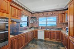 122 NORTH KIAMA DRIVE KIAMA DOWNS NSW 2533 Jones Beachfront - Rare Offering! This is a unique and unparalleled opportunity to acquire a beachfront property on Jones Beach. This five bedroom home has prime position with direct access from your back yard to the sandy shores and rolling waves of the beach. The three level double brick home offers four bedrooms, ensuite and main bathroom on one level, and a fifth bedroom with attached lounge area, kitchenette and bathroom suitable for guest accommodation or valuable self contained holiday accommodation on the lower level. Three of the five bedrooms also enjoy commanding ocean views and outlook. Open plan living, dining and kitchen with breathtaking ocean views and a functional fireplace, are located on the upper level extending out to a sublime alfresco deck. - Beachfront location with direct access and spectacular views - Spacious and solid construction over three levels - Five large bedrooms, three with access to a large balcony and ocean views - Open plan living areas enjoying natural light and a sea breeze - Entertaining bar and fully functioning fireplace - Walk to Kiama Downs shops and Surf Club A very rare offering. Properties of this calibre along Jones beachfront are few and far between. Don't miss the opportunity to secure a piece of this tightly held paradise.
