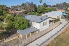 1/4 Russell Road Greenmount WA 6056 $329,000 First home-buyers should rush to this well-maintained and renovated 3 bedroom, 1 bathroom home. Elevated above the road, hidden behind established gardens, entered via a shady front verandah, the home features original jarrah floors and benefits from high ceilings and a wonderful sense of space and light. 3 bedrooms 1 bathroom Jarrah floors high ceilings Large family living area Open kitchen & dining Ceiling fans in bedrooms Park views from rear deck Sec garage with workshop Easy-care courtyard garden Gently elevate 465m blk Foothills convenience Buyers looking for a property that won’t overwhelm them with work to be done, will be delighted by this 3 bedroom, 1 bathroom fibro and iron home. Move-in ready, the property is surrounded by established gardens, elevated on the block and overlooking a park. A cheery Jacaranda at the driveway is the perfect welcome to the light-filled bungalow shining with original charm and modern practicality. The home has been treated to a subtle yet effective renovation. The open plan lounge and dining is luminous; light walls, rich jarrah floors and views to the neighbouring park make for a modern room with a floorplan that allows for a variety of configurations. A slow combustion fire sits in one corner for maximum efficiency. A carpeted area wraps one end of the lounge and opens to the rear deck; the perfect place for a formal dining area with the option of indoor outdoor living in place The functional kitchen includes a breakfast bar, freestanding oven and wrap around bench. Adjoining the kitchen is a large modernised laundry that is ideally-situated for conversion to a combination scullery if required. The bedrooms are all a good size and feature ceiling fans and original wooden floors and window frames. Arranged in one side of the home, they form a distinct, private zone along with the family bathroom and separate W.C. At the south-east corner of the home, a decked verandah sits elevated to provide views of Fraser Park and the paved courtyard garden. Accessed via the lounge or laundry, this cool shady spot is a beautiful place to enjoy alfresco dining or just idle away an hour or two in the afternoon. In the undercroft, the property features a secure garage with a workshop space as well as a freestanding carport. A neutral colour scheme, good-sized rooms and original features fashion a comfortable property that delivers ease and character. Set within a minute’s walk of two local schools, the property is convenient to the airport as well as the amenities of Midland. On the weekend those in search of outdoor adventure will find it at the nearby John Forrest National Park and those looking to unwind are close to all the attractions of the Swan Valley. If you have been looking for a fantastic value, fuss free home with some heart and soul, then you may have found it.