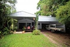 1235 Old Tully Road Maadi QLD 4855 $295,000 * Tropical and peaceful property * Spring fed creek plus bore! * Rainforest plus some fruit trees Getting back to nature is said to be good for the soul. Why not treat yourself to a space where you can relax and enjoy the best that nature has to offer. This 10,000m2 (1 hectare) property is very private and peaceful with rainforest gardens and mature fruit trees scattered throughout the yard. Fresh water will never be an issue, with a spring fed creek running along the rear boundary of the property, plus the advantage of an operational bore. As you make your way down the picturesque driveway to the quaint 2 bedroom home, you'll feel like you are miles away from everything. Yet, the conveniences of Tully and the beauty of Mission Beach are only a 15 minute drive away. Key features of the property include: * 2 good sized bedrooms with built in robes * Open plan living / dining * Separate media room with built in lounge seat * Solid kitchen overlooking the living area, with electric oven and cooktop * Timber decking area for entertaining friends and family * Double carport + workshop area * New awnings, gutters, insulation and ceiling fans * Large water tank that can be filled from the bore (via pump) * Spring fed creek running along the rear boundary * Lush gardens - a mix of rainforest, formal gardens and lawn.
