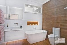 20 Janet Ave Thornleigh NSW 2120 $1,280,000 to $1,350,000 The combination of a versatile floorplan, a contemporary renovation and extension plus a spectacular outlook create this home with a DIFFERENCE. A winning location too . . .nestled in a quiet, leafy pocket yet just a convenient 5 min. walk to the train station and shops. Charming features greet your inspection: a tiled front porch overlooking the established, private garden, polished timber floors throughout, high 2.7m ceilings with skylights to capture natural light, r.c air- conditioners and bespoke glass feature windows. Designed with family in mind the open- plan living and dining flow directly to the modern kitchen with Caesarstone benches, chef's oven, pantry, dishwasher and a high set leafy outlook. Particularly spacious bedrooms with built-in robes and ceiling fans, the main bedroom features built-in cabinetry and robes, modern ensuite, ceiling fan plus air-conditioning. And WOW, the new main bathroom in vogue style is designed for comfort and convenience, complete with skylights, designer lighting and recessed niches designed for the shower and over the luxurious stone bath. A BONUS room is the particularly generous 4th room, with versatility as a bedroom or that extra TV room, teenage retreat or study, leading through double French doors to the lovely rear deck and view. A fabulous alfresco entertaining deck flows seamlessly from the living space, set beneath the main roof allowing year-round outdoor living, dining and relaxation. Complete with an in-built BBQ and fridge cabinet connected to mains gas, the high set aspect of this deck offers an impressive view; a tranquil leafy outlook plus privacy. The designated home office downstairs benefits from its own separate access, ideal for the home workspace AND . . .the home handy person, hobbyist or tradie will be amazed at the full under- house storage and workshop space with power, lights, work bench and standing height. The landscaped rear yard features level, sandstone- terraced lawns, complete with feature lighting and a fountain, securely fully fenced and just perfect playing or gardening. Some of the extra features in this home include: camera monitored security system, gas cooking, gas hot water and gas heating, an internal air extractor system to assist with climate control, huge water tank for the garden and auto-garage door plus ample space to park a trailer, van or extra vehicles. Convenience plus . . . with Sydney Adventist Hospital, National Park, bush- walking tracks, M1 and M2 access and an impressive list of sought-after schools all within easy access from this property. Set on a 734m2 block, this MODERN home is a refreshing opportunity, don't miss this inspection.