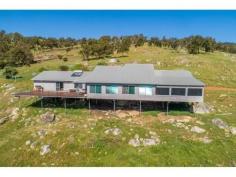 1568 GREAT NORTHERN HIGHWAY UPPER SWAN WA 6069 $1,760,000 A stunning 58 acre rural property just 45 minutes or approximately 33 kms from the Perth GPO. Nestled high up on the escarpment this custom built farmhouse has large open plan living areas and 2 expansive deck areas all taking in the uninterrupted views over the Swan coastal plains from Bullsbrook to the city. There are 5 double bedrooms, 2 bathrooms, an upstairs office and a separate activity/media area for the children. 4 bedrooms have bi robes and the master bedroom has a walk through dressing room to the ensuite with a spa bath. Extras include a 3 bay carport under the main roof, a farm size laundry, reverse cycle air conditioning, a slow combustion wood heater, solar power connection with 2 x 2.5 kilowatt inverters and mains water access. The farmhouse overlooks 5 fenced paddocks with a dam and windmill providing water to each paddock. There is also a 5,700 kilolitre water licence that remains as part of the sale of this property.