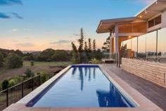 Lot 8 176 Fowlers Lane Bangalow NSW 2479 $2 - $2.2m Avoid the hassle of building - we have a NEW LUXURY, DESIGNER HOME with quality throughout! With DA in place for triple car garage & self contained STUDIO. An architecturally engineered, passive solar designed & cyclone rated construction, featuring glass, concrete & steel including expansive commercial grade doors & windows - capturing coastal breezes for cross ventilation, Pacific Ocean glimpses for sunrises & breath taking sunsets across a rolling, rural landscape. Seamless indoor/outdoor living with all rooms flowing to ironbark decks, balconies & level lawn to the north, with the entertaining deck at the rear flowing on 3 sides to the 15 metre mineral salt lap pool looking out to spectacular views across the valleys & hills below. Wide board Northern Beech flooring throughout, extensive timber cabinetry & stone finishes - marble in the bathrooms with under floor heating & travertine in the laundry - affording a feel of natural luxury & timeless elegance. Three oversized bedrooms are separated from the open plan living by a sizable breezeway with options for a 4th bedroom if you wish but currently offering additional all weather living. The master features a grand walk through wardrobe & en-suite with a modern oval stone soaking tub to wile away the sunsets. Bedroom 2 features a walk through wardrobe opening to level private lawn & gardens & bedroom 3 a substantial built in (all with LED strip lighting). Bring your own style & class & make this property truly yours, by adding your own minor finishing touches. On just under 2 acres of landscaped, easy care grounds & yard with a rear rural paddock for pets & play - the property is on a community title rural development (like a strata for rural) which offers a rural lifestyle on 113 acres with swimming holes, a community hall & machinery sheds taken care of by a farm manager.