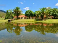 2448 Beaudesert Nerang Road Canungra QLD 4275 $1,775,000 2 Luxury homes situated on over 10 acres with approx 270m creek frontage! This is one of those properties that many people dream of and it could be yours... The acreage is fully usable, fertile and private with unlimited water supply from the creek and bore to service any of your hobbies you wish to pursue. Main residence, tastefully renovated: * 3 spacious bedrooms with an ensuite, including spa, off the master bedroom which opens up to the outdoor area. * Spacious kitchen overlooking the large open plan living and dining area with crisp/fresh decor opening up to the welcoming in ground pool. * Ducted air conditioning to cool and heat the home and a combustion heater and fans throughout. * Main bathroom located across from the 2 bedrooms with separate toilet, as well as a study large enough to be a 4th bedroom. * Double garage with remote controlled doors. The Cellar house: This is something spectacular, particularly for those that love to entertain. It is also overlooking the stunning pool and a recently built gazebo. It boasts a massive open plan area with teppanyaki kitchen that is an ideal area to have a game of billiards. It features a cosy open fire, ducted heating and cooling and separate bathroom, oh and to add to the sense of luxury there is also a sauna! Complete with another living and dining area, kitchen and a bedroom that would suit a king complete with ensuite and walk in robe, this is a beautiful home all on it's own. This is perfect for the extended family, young, old, or perhaps an extra income for holiday letting, being so close to town and all the activities the Scenic Rim has to offer. Internal stairs take you down to the enormous wine cellar, with walls lined with wine racks to hold your special collection and is complete with another kitchen. It's the perfect place to entertain with a difference. It has the feel of a high class restaurant at a vineyard. Outdoors: 12 x 6 m shed with power, awning and large avairy that could be converted to stables and separate paddock with equine fencing. Outlets around the property to supply water for irrigation to the established gardens, lawn/paddock and impressive palm trees. Picturesque dam full of turtles and an ideal area to sit back and take in nature and the stunning surrounding views. Or sit by the creek and enjoy the flowing water at your feet. The opportunities for this property are endless, particularly for our growing community and tourism. Only minutes to local cafes and speciality shops which thrive on the weekends. This property is certainly one that you must inspect to appreciate all it has to offer.