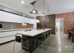 5C KISHORN ROAD Applecross WA 6153 $1,999,000 Register your interest today in this amazing home. Beautifully presented and as-new. This modern home makes no compromises with high-end designer interiors meeting elegant alfresco living on a superbly manicured 704sqm green-titled block with in-ground pool. The spacious single-level floor plan also offers plenty of space, for family living, and you’ll love this convenient family-friendly location that’s opposite Applecross Primary School parklands, and just moments to Ardross Street cafes and shops. -- Living/dining area with polished concrete floor, modern chandelier and stylish feature wall -- High-end designer kitchen with stone bench tops, sleek cabinetry and premium appliances -- Generous home office or additional living space off the main living/dining area -- Carpeted, king-sized master bedroom with large walk-in robe through to luxury ensuite -- Three large additional bedrooms plus an extra sitting room provides even more living space -- Stunning main bathroom with twin vanity, bath, shower and private alfresco terrace -- Large integrated entertainer’s patio features high-end alfresco kitchenette with fridge -- Secure, manicured grounds plus a sparkling in-ground pool with frameless glass fence -- Well-equipped internal laundry with plentiful cabinetry and powder room with vanity -- Gated front access to private front yard with large lock-up garage and solar power system Secure gate entry ensures your privacy as you enter into the fully fenced front yard that features manicured lawns and a sparkling in-ground pool with frameless glass fence. Continue inside where the stylish open-plan living/dining area will impress with premium on-trend styling including polished concrete flooring, a raw brick feature wall, distinctive contemporary light fittings, an over-sized Plantation-style ceiling fan and a stunning atrium-style ceiling recess to the living area. The immaculate high-end kitchen will fulfil every home chef’s wildest dreams, and entertaining is a real treat on the large integrated patio with alfresco kitchenette. The king-sized master bedroom is another standout feature of the home with a large walk-in robe and luxury designer ensuite that features a striking freestanding bath, twin vanities, floor-to-ceiling tiles and a large open rain-head shower behind a stunning raw brick partition. An additional sitting room and a generous home office provide even more living space, and the large second, third and fourth bedrooms – all with built-in robes – share the quality family-sized main bathroom to complete this impressive package. For more info, call Frank Sanchez on 0419 367 999 or Mike Quirici on 0402 085 533. DISCLAIMER: Whilst every care has been taken with the preparation of the particulars contained in the information supplied, believed to be correct, neither the Agent nor the client nor servants of both, guarantee their accuracy. Interested persons are advised to make their own enquiries and satisfy themselves in all respects. The particulars contained are not intended to form part of any contract.