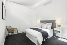 7/680 Victoria Street North Melbourne VIC 3051 Cleverly designed, this architecturally enhanced two bedroom townhouse enjoys a quiet rear aspect in the boutique Unique Electrics Building warehouse conversion. Soaring ceilings, vast glass aspects and innovative design combine creating a generous living domain featuring custom-built study area, walled storage and large sliding doors extending onto a private alfresco terrace. Stone bench tops, quality cabinetry/pull-out pantry and stainless steel appliances complement a modern kitchen. Features oversized bedrooms, built-in-robes, designer bathroom/laundry, powder room, split-system air conditioners, quality hardwearing flooring, keyless entry/alarm and basement car space/storage locker. Currently zoned for University High, near Errol Street cafés, restaurants, shops, Queen Victoria Market and public transport.