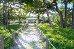 20 DONKIN Lane Mission Beach QLD 4852 $1,100,000 This beautiful beach house is situated on a corner site in much sought after Donkin Lane only a heartbeat away from the restaurants, boutiques and cafes in the Mission Beach Village. This holiday home is offered for sale fully equipped with quality appliances and furniture, so you're ready to holiday let this popular home from day 1 and take advantage of its advanced bookings. The home is on a level 809m2 allotment with views out across the Coral Sea to nearby Dunk & Bedarra Islands (plus 10 other lush tropical isles) in Great Barrier Reef Marine Park waters. There are ocean, beach and island views through the coconut palms and lush tropical vegetation from the huge living area, beachside patios and from the 2 main bedrooms, each with new ensuites. There are 3 bedrooms and 3 bathrooms in the main residence. The clever floor plan includes a house sized' studio, removed from the main residence, but under the same roof. It contains a modern kitchen, living/lounge, bedroom and new bathroom and sleeps 5 (with 2 extra singles in the studio). Other Features include: Separate fully equipped Laundry with modern appliances Pool in a lush tropical garden setting Fully air conditioned throughout with modern split air units and ducted air unit in lounge/living area New state-of-the-art kitchen with Fisher & Paykel stove/oven; granite bench tops and island bench Huge 437m2 (est.) total area under roof Solid rendered cement block walls; fully tiled throughout 160m2 (est.) of undercover shaded patios for cool, relaxed tropical living Immediate cash flow as a Holiday Home Whatever You Do, Don't Buy a Beachfront Home until You See this Tropical Gem! Highly Recommended and Seriously for Sale! Exclusive Agent Dick Williams 0419 734 705 FEATURES: Air Conditioning Built-In Wardrobes Close To Shops Fully Furnished Holiday Home Garden Pool Terrace/Balcony