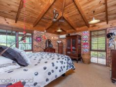 15 Milligan Road Parkerville WA 6081 $699,000 Come home to the beauty of nature with this 3 bedroom, 2 bathroom brick and iron home. The 1983-built Kentucky Homes residence is in perfect harmony with its natural 5-acre landscape and offers fantastic outdoor living and entertaining on the wide, elevated verandah. A floorplan that delivers formal and informal living gives you the flexibility to utilise spaces in a way that suits your lifestyle and the seasons. 3 bedrooms 2 bathrooms 1983-built brick and iron High pine-lined ceilings Open family and kitchen Formal lounge and dining Junior wing with activity Elevated, shaded verandah 4-car carport + workshop Natural 5-acre cul-de-sac Perfection in Parkerville Homes that have only ever known one owner are invariably imbued with love and an atmosphere of instant welcome – a sense of ease and contentment envelopes this 1983-built brick and iron home. From the private cul-de-sac address and the soothing natural setting to the warm, well-designed home with exposed brick and high ceilings, this property is a lesson in living lightly in the Hills. A wrap around verandah paved with bricks draws you to an expansive alfresco entertaining area and into the open plan family room, and kitchen arranged at the centre of the home. Exposed brick, a slow combustion fireplace and high, pine panelled ceilings deliver a cosy and airiness. A brick surround houses a slow combustion fireplace in the family room and an open fireplace in the formal dining and lounge room to create a central heat bank. Cork floors and pine cabinetry give the kitchen an organic style while electric hotplates, a wall oven and dishwasher fashion a user-friendly space with a large pantry. To one side of the central living area is the formal dining and lounge room. A ceiling fan and open fireplace ensure this space is ready for year-round entertaining while high ceilings and views of grass trees and eucalypts fashion a serene second living area. Arranged across the eastern face of the home is the main bedroom suite consisting of a large bedroom, walk-in robe, ensuite and private study. Reverse cycle air-conditioning and a ceiling fan manage climate control in this separate adult zone. A good-size study offers a private retreat that could be styled as a secluded library or spacious dressing room. A design that allows areas of the home to be closed off when not in use makes this home a great fit for young families, those with teens and empty nesters who like to have guests. A separate junior wing at the western end of the home contains two junior bedrooms, a family bathroom and a large activity/studio room opening to the verandah. The large activity/studio is suited to various uses. Light-filled and looking out to the south, this space would make a terrific activity room, studio or crafting room. Extending out from the activity room is a wide alfresco entertaining area with a deep gabled roof extending low on the western edge. This elevated and paved space provides a beautiful outdoor dining area or a fabulous place to sit and absorb the beauty of your surroundings. Towards the front of the property are a large powered workshop, separate storage area and a 4-car carport. The home benefits from both scheme and bore water and has sprinklers fitted to the roof. Everything you imagine should be a part of Hills living is here: a private natural setting, a charming, comfortable home with a flexible floorplan and fabulous outdoor living just minutes from the bustling Mundaring Village.